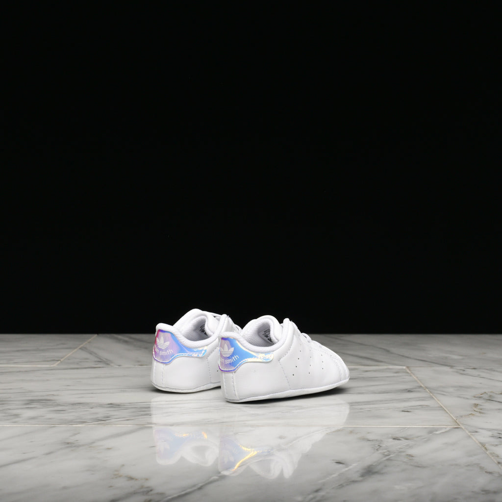 Toddler wearing Stan Smith crib shoes, showcasing comfort and style.