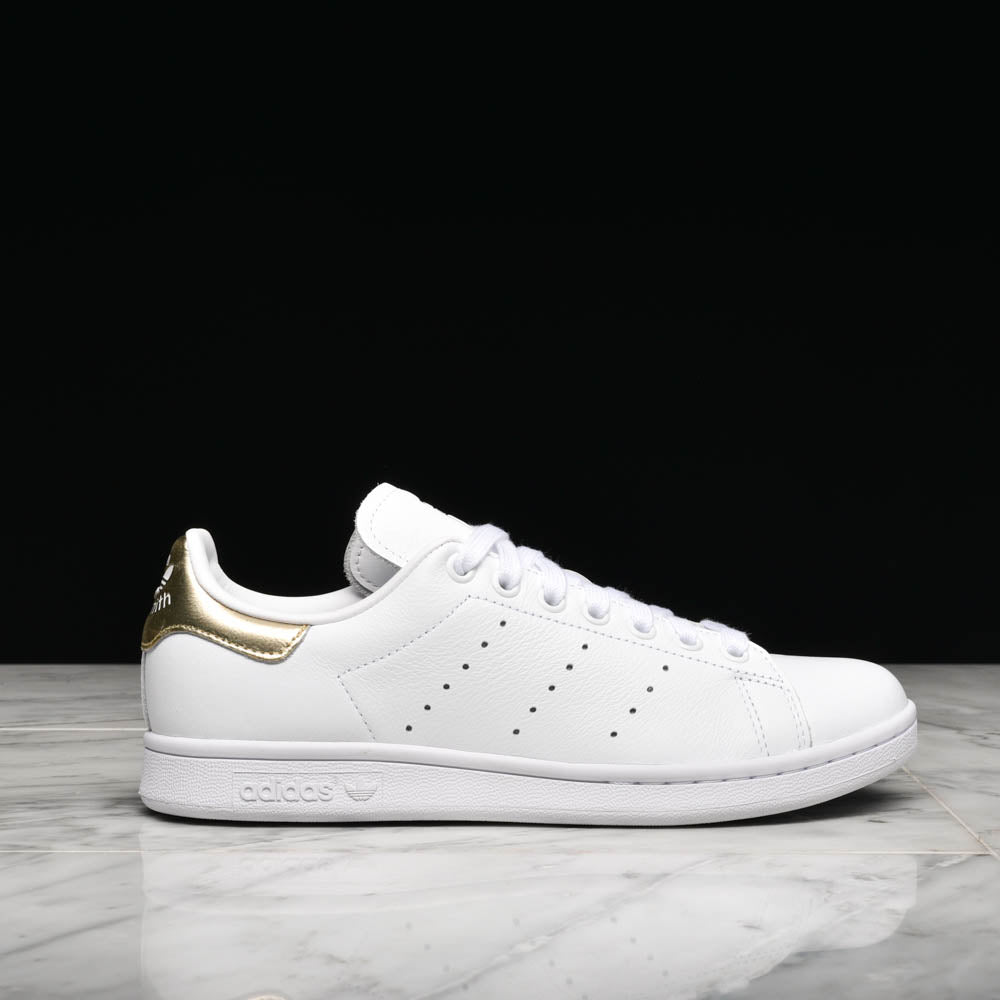 Side view of women's adidas Stan Smith sneakers in white and gold metallic