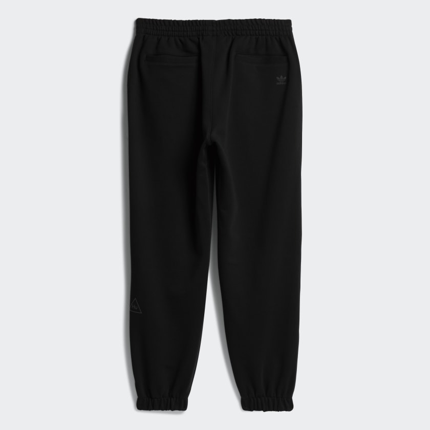 Side view of Pharrell x Adidas joggers highlighting the tonal Trefoil logo and Human Race detail.