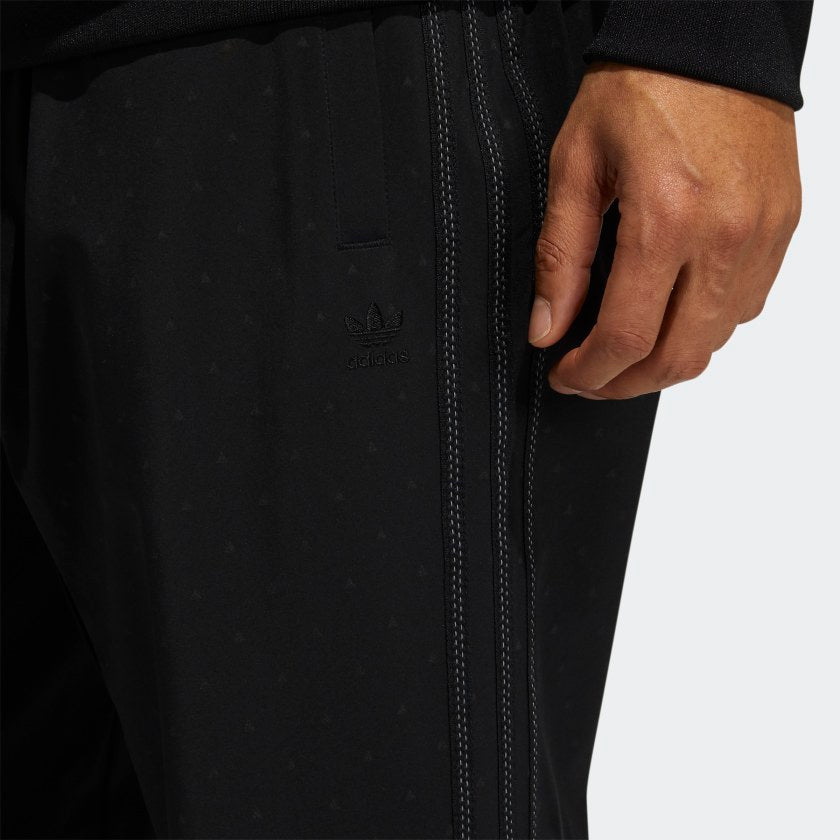 Detail shot of reflective stitched 3-Stripes on adidas track pants