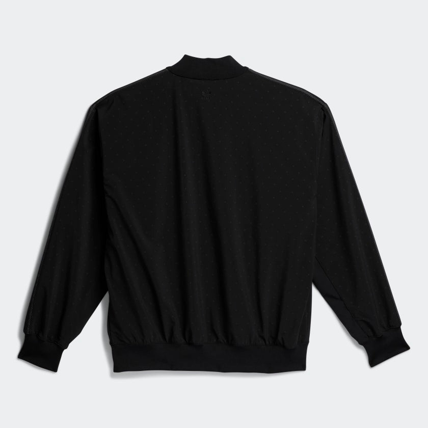 Close-up of the reflective print and tonal 3-Stripes on the adidas black athletic jacket